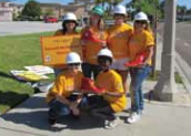 Members of the San Marcos team in orange shirts and white work hats pose for a picture. They helped raise money for the Ronald McDonald House. Back row: (left to right) Teresa Quintero, Niki Rademacher, Kim Rademacher, Melissa Villareal. Front row: (left to right) Tina McGilvery, Tamika Watts.