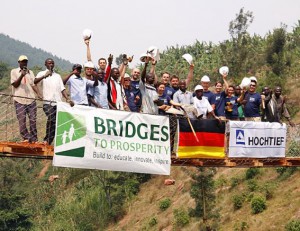 photo of HOCHTIEF with the Bridges to Prosperity team on a footbridge