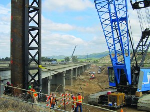 photo of the Flatiron Construction Santa Maria Bridge and Road Work site with a blue crane in the foreground