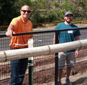 Brian Kerschen, Vice President of Procurement and Jake Duffy, Buyer assisting in the garden.