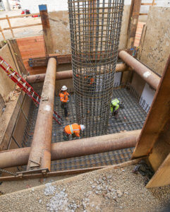 Photo of concrete bridge footings and columns that were recently formed and poured