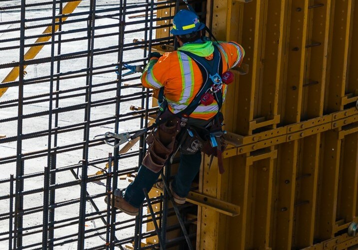 man scaling rebar wall