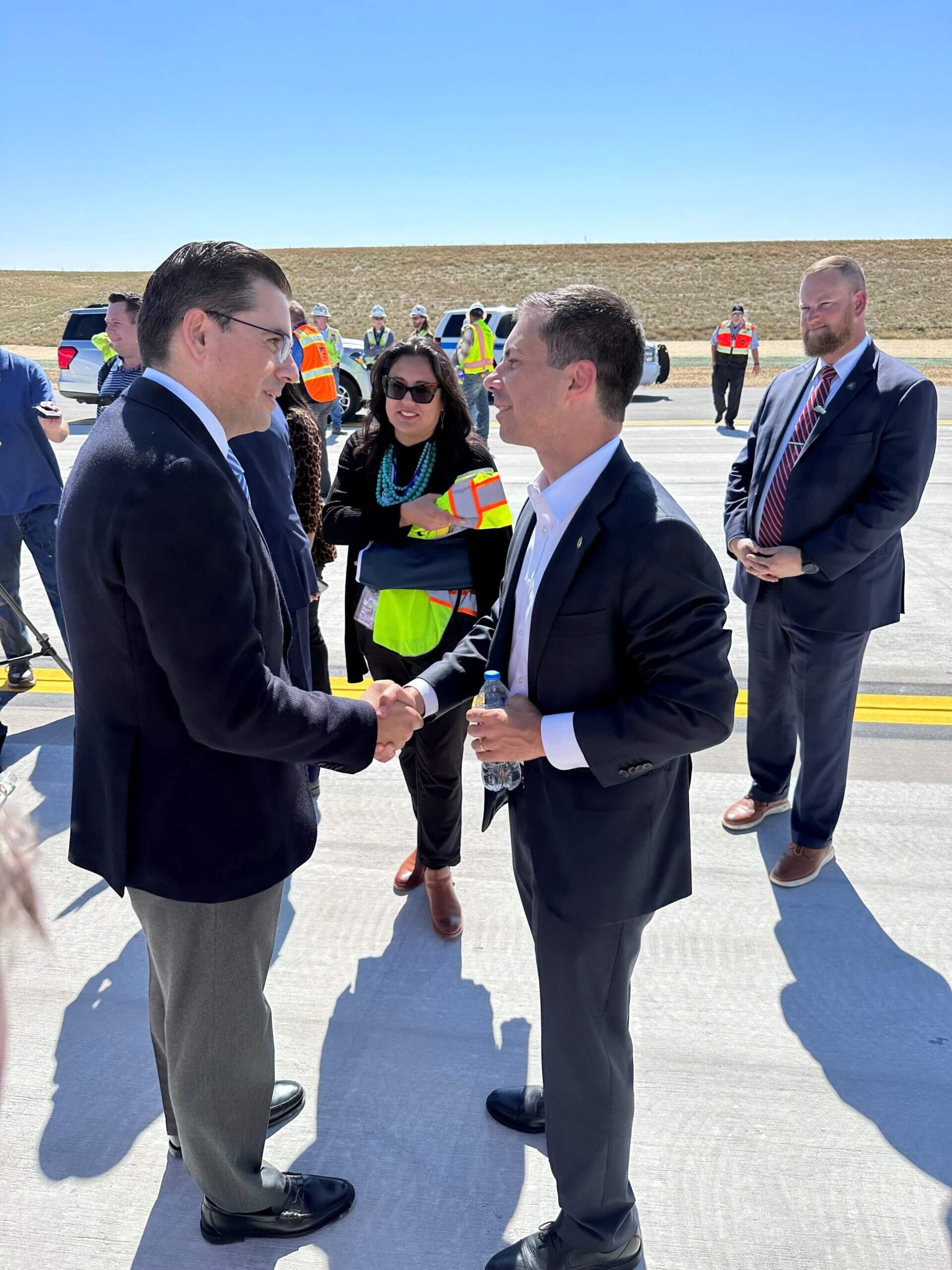 Flatiron President & COO Javier Sevilla shakes hands with U.S. Secretary of Transportation Pete Buttigieg