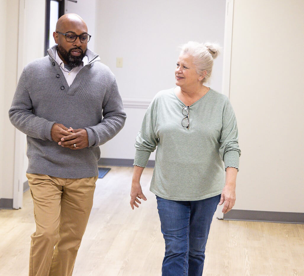 Corey Morgan chats with co-worker Michelle Kreger in Flatiron’s Charlotte office. 